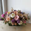 A lush, garden-style centerpiece that reads like a springtime poem-perfect as a