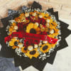 A bold, rounded bouquet that pairs classic red roses with sunny sunflowers