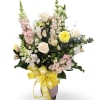 Pale cream roses and soft pink snapdragons give this tall, airy flower