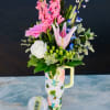 A fresh, garden-inspired mix of seasonal blooms in soft pinks, whites, and