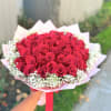 Bouquet of red roses with white baby's breath in pink wrapping