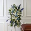 A graceful standing spray featuring a serene combination of blue hydrangeas, white