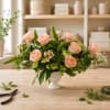 Soft peach roses gathered in a low, full design give this flower