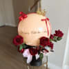 Valentine's Day balloon arrangement with red roses and a gold crown