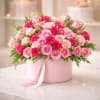A lush dome of pink, blush and red roses set inside a