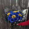 Bouquet of blue and gold roses wrapped in black paper