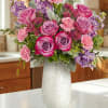 A soft, elegant blend of premium roses in shades of lavender and