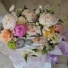A special Mother&rsquo;s Day flower basket paired with delicate macarons, creating a