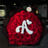 Large bouquet of red roses with a white floral monogram