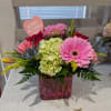 Bright, seasonal blooms in a glass cube