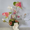 A sculptural, art-forward arrangement that blends tropical elegance with airy spring textures.