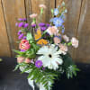 Fresh seasonal assortment of pastel and white flowers with lush greens