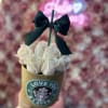 White roses in a gold cup with a black bow