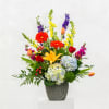 Colorful mixed flower arrangement in a gray vase