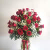 Bouquet of red roses with baby's breath in a glass vase