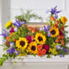 Bright mixed bouquet with sunflowers, purple irises, and orange roses