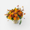 A vibrant, modern arrangement bursting with golden yellows, warm oranges, and rich