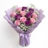 A lush cluster of pink and purple roses creates an immediately romantic