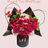 Bouquet of red roses and white hydrangeas in a black box with butterfly accents