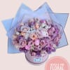 Large bouquet of pink and lavender roses in a round box
