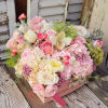 Pink and white mixed flower arrangement in a pink box