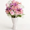Soft pink roses paired with purple daisy-like blooms and delicate pink alstroemeria
