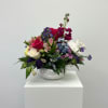 Bright pink and white roses mingle with purple asters and soft pink