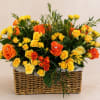 A charming basket arrangement combining mini yellow and orange roses, enhanced with