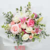 A beautiful mix of soft pink and ivory seasonal blooms, thoughtfully arranged