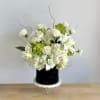 A fresh mix of white and green blooms, beautifully arranged in a