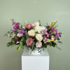 A lush, low centerpiece that feels like a secret garden-this flower arrangement