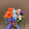 Bright mixed-color bouquet with gerbera, hydrangea, spray roses, hyacinth and asters, finished
