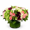 Lush and romantic, this garden-style arrangement features soft pink peonies and roses