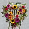 Standing Heart spray filled with colorful flowers.