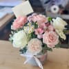 Seasonal spring flower selections in blush tones in the stylish ceramic vase