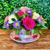 Designers choice flowers in a randomized antique teacup 