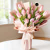 Pink tulip bouquet wrapped in blush paper with a ribbon