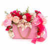 A charming arrangement of lush pink roses, peonies, orchids, and fillers beautifuly