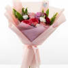 Wrapped in soft blush paper and tied with a satin‑pink ribbon, this