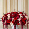 A lush cascade of saturated reds, blush pinks, and creamy whites creates