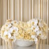 A timeless expression of elegance, this luxurious arrangement blends cascading white orchids