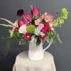 Capturing the untamed beauty of a wild meadow, this vibrant arrangement is
