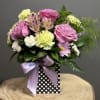 A graceful blend of roses, alstroemeria, and carnations in gentle hues, accented