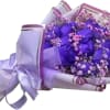 Bouquet of purple roses with pink baby's breath in lavender wrap