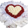 Heart-shaped bouquet of red and white roses wrapped in white paper