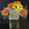 Bright orange gerbera, yellow daisies, with orange carnations and pale green hydrangea