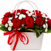 A dense cluster of red roses framed by delicate white button blooms