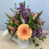 Beautiful assortment of Spring flowers in a watering can to shower Mom