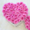 Heart-shaped bouquet of pink roses in a white box