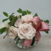Twelve sand-colored roses with lemon leaf and mint accents, finished with a